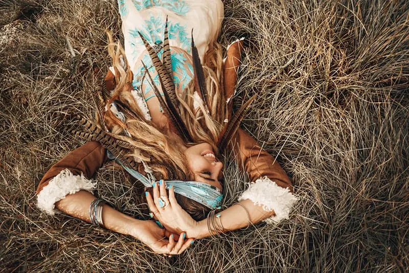 boho girl laying on the grass