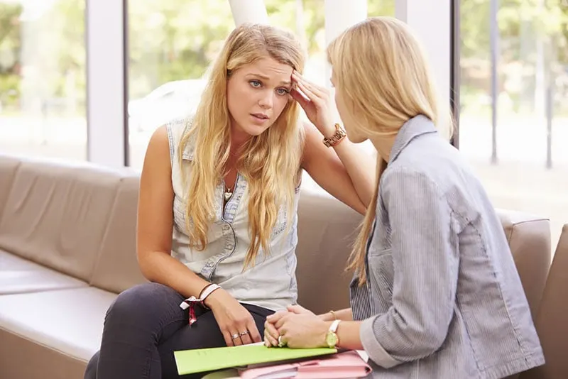 exhausted woman talking with friend