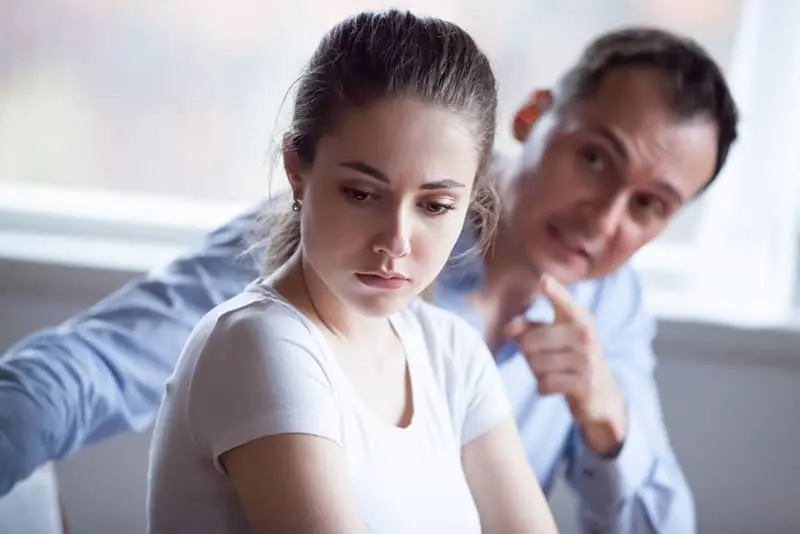 frustrated woman listening to angry man
