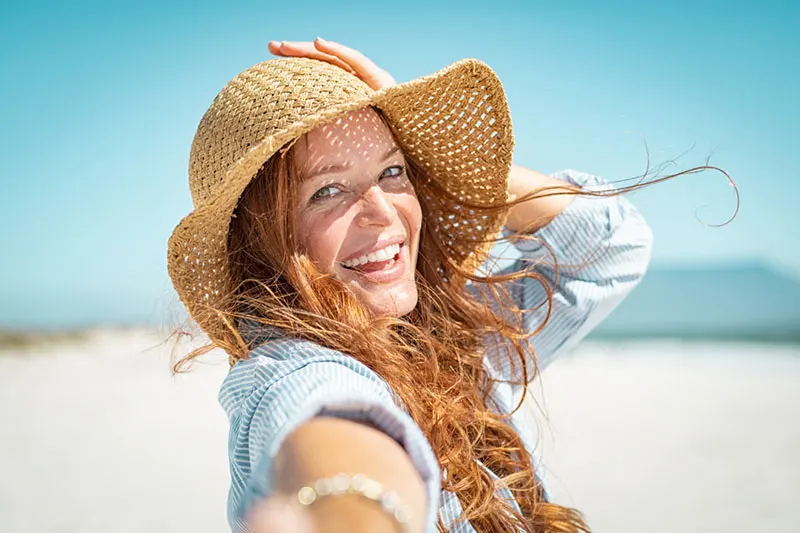 happy woman with hat posing