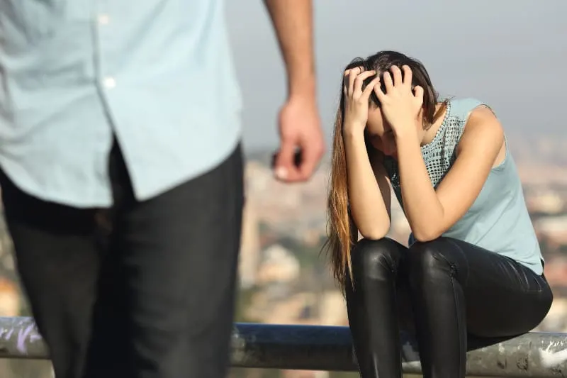 man leaving crying woman outside