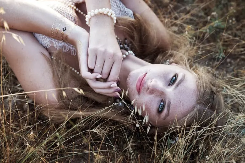 nice blond woman laying on the grass