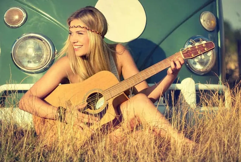 nice blond woman playing a guitar
