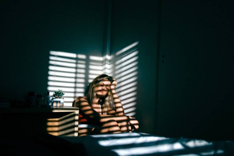 pensive woman sitting at home