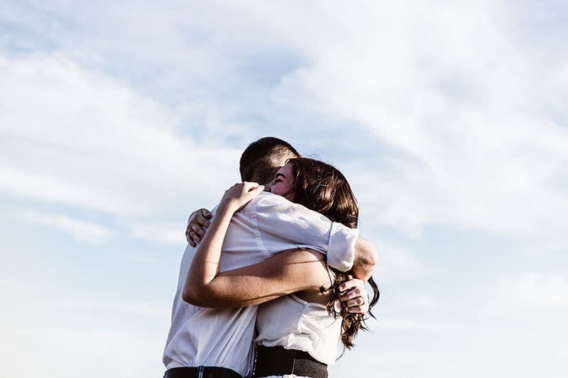 couple hugging in sunshine