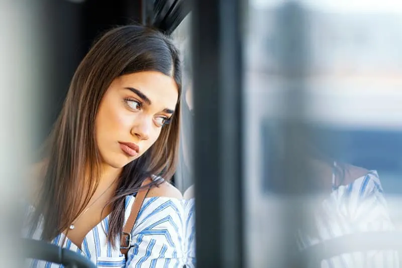 sad woman sitting in the bus alone