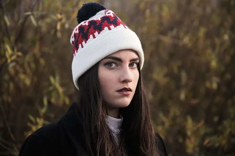 serious woman wearing winter hat
