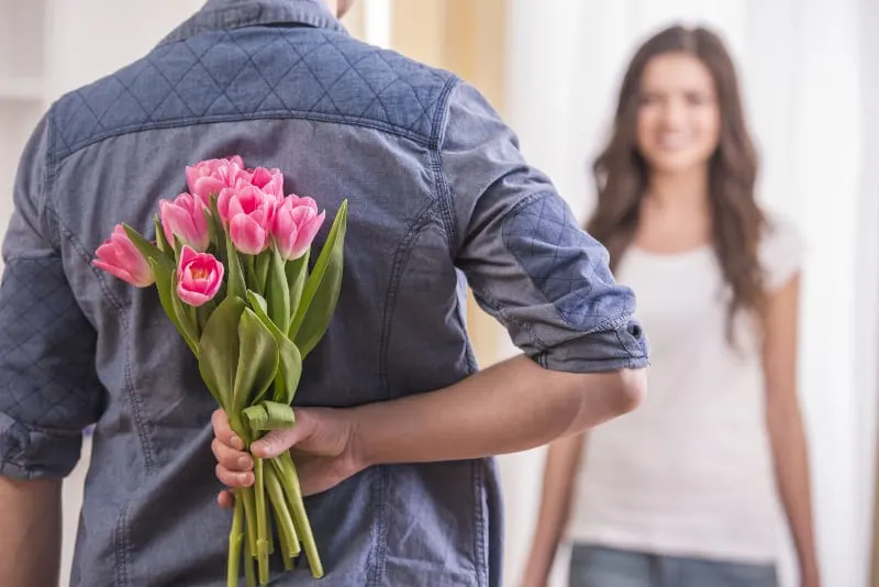man giving flowers to his woman