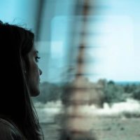 Sad woman traveling with train