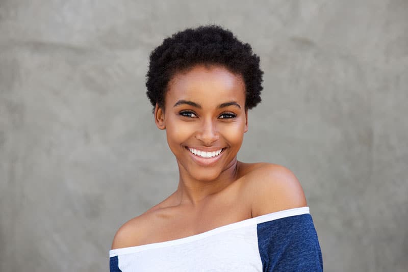 Close up portrait of smiling young modern black woman