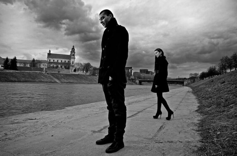 Beautiful stylish pair of young people outdoor going in different directions.