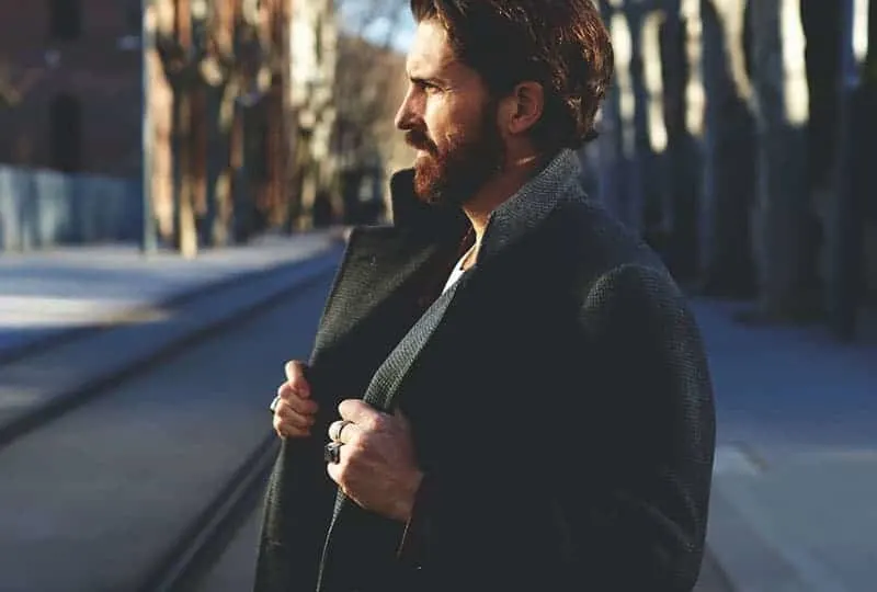 side view of man wearing black coat
