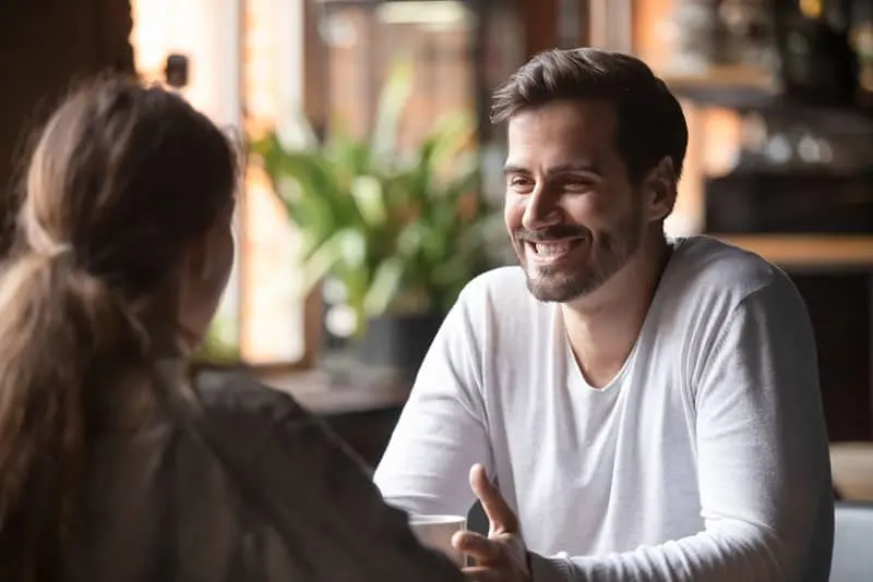 smiling man looking at woman