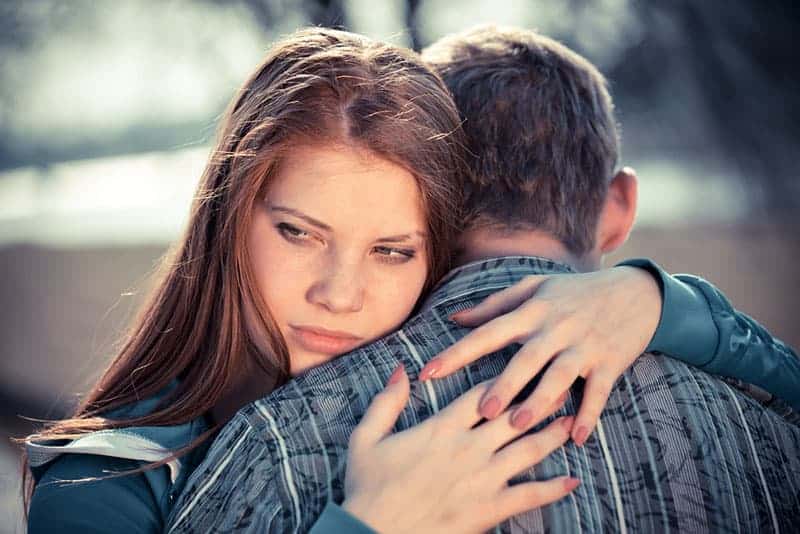thoughtful woman hugging a man