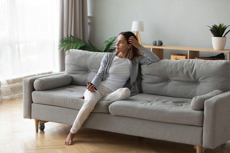 woman sitting alone on the couch at home