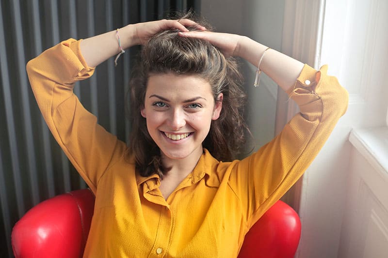 happy woman in a yellow shirt