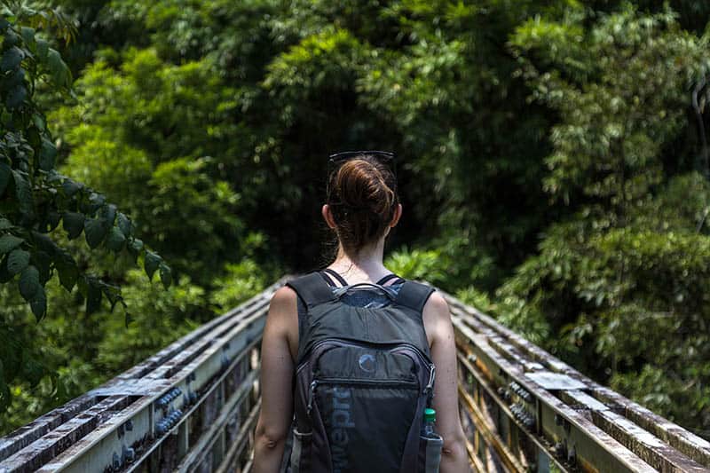woman with backpack walking in nature