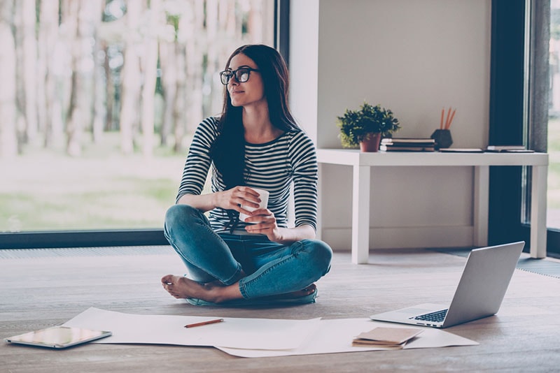 young woman working on the floor at home