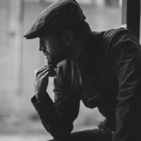 handsome man with hat looking away