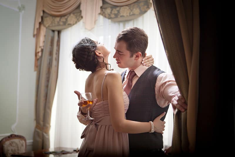 Kissing couple on the vintage interior background.