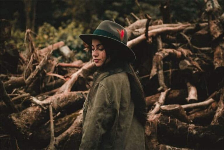a woman with long black hair with a hat on her head