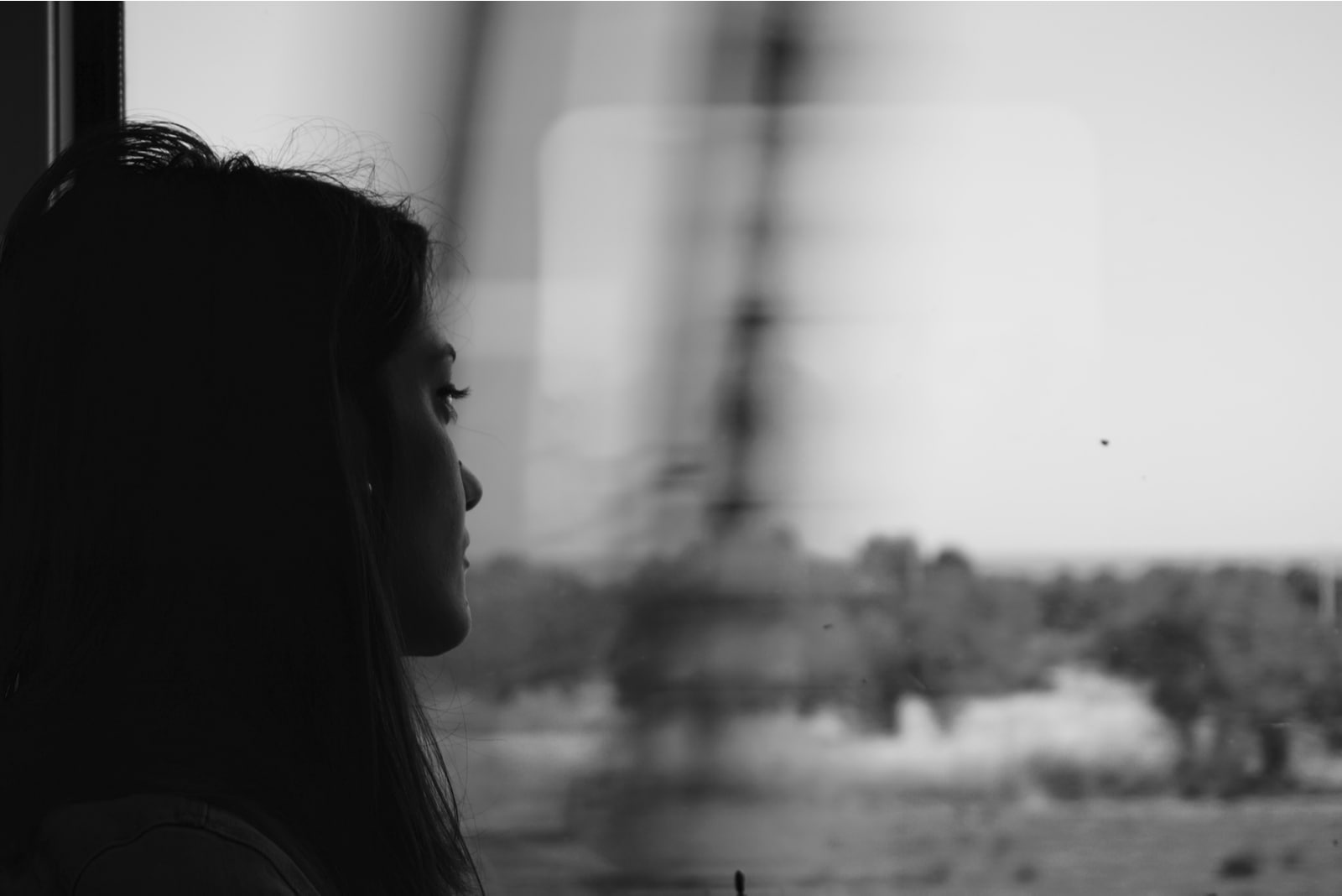 Sad woman traveling with train, alone