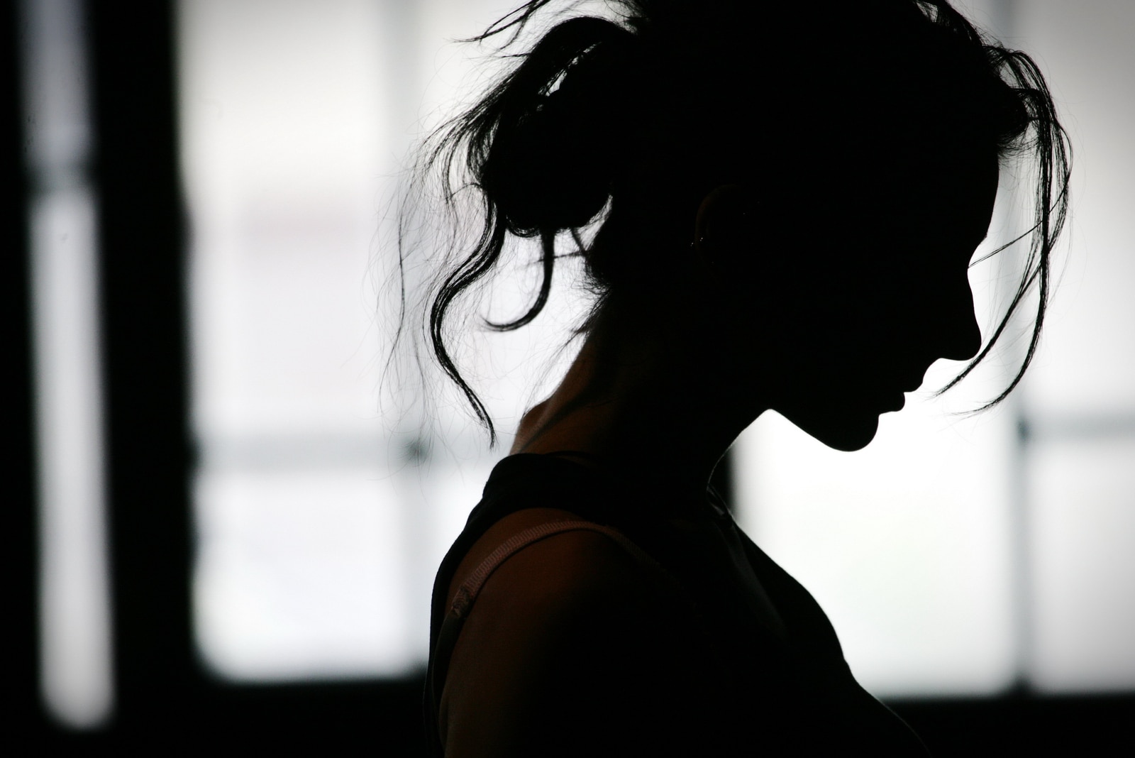 Silhouette of womans head with waving hair