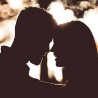 silhouette of couple standing close to each other