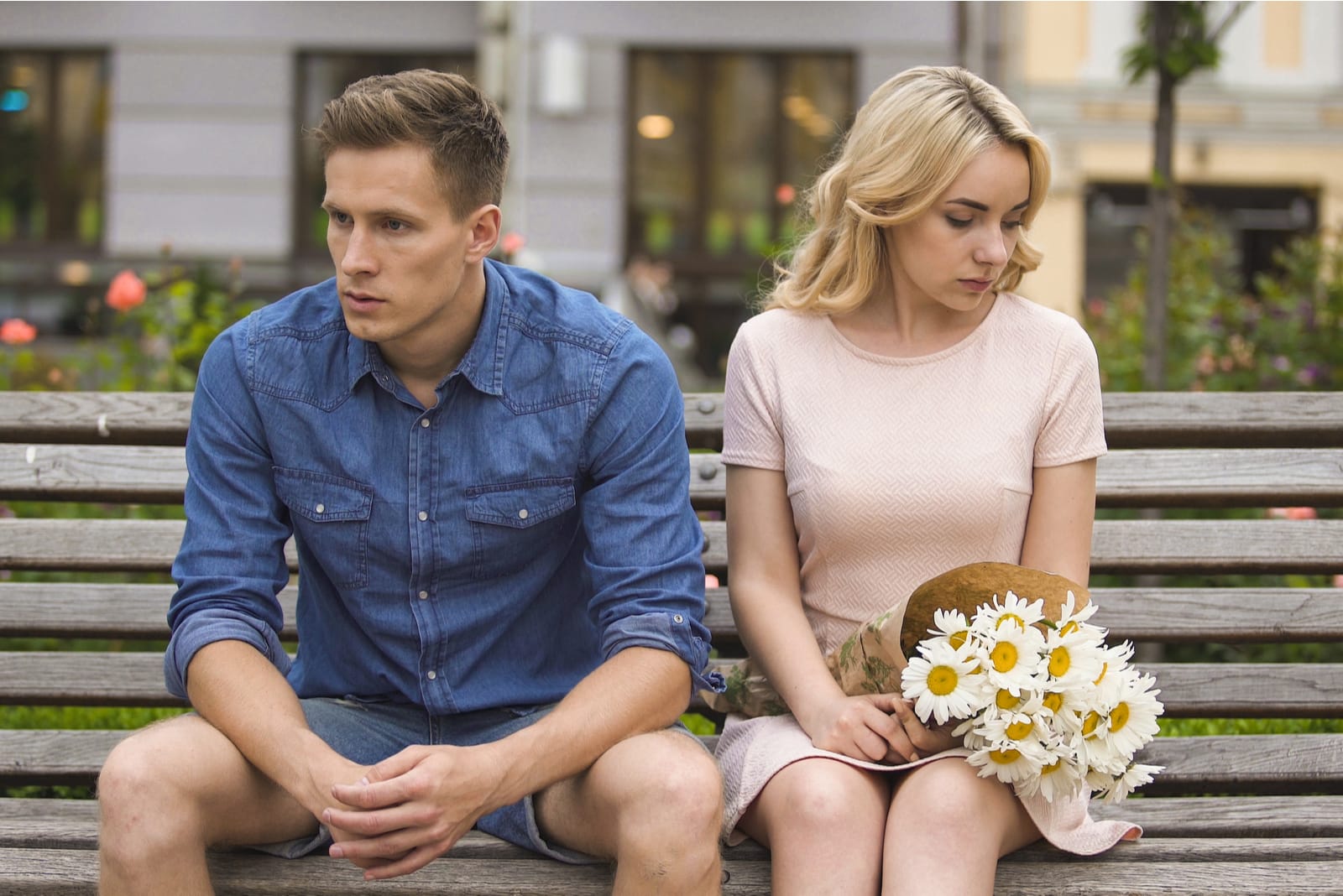 Unhappy couple sitting after fight