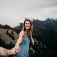 man holds smiling woman's hand