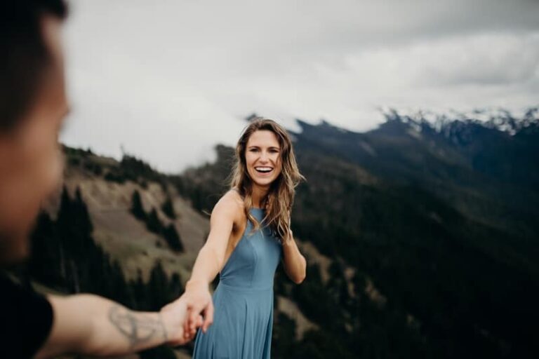 man holds smiling woman's hand