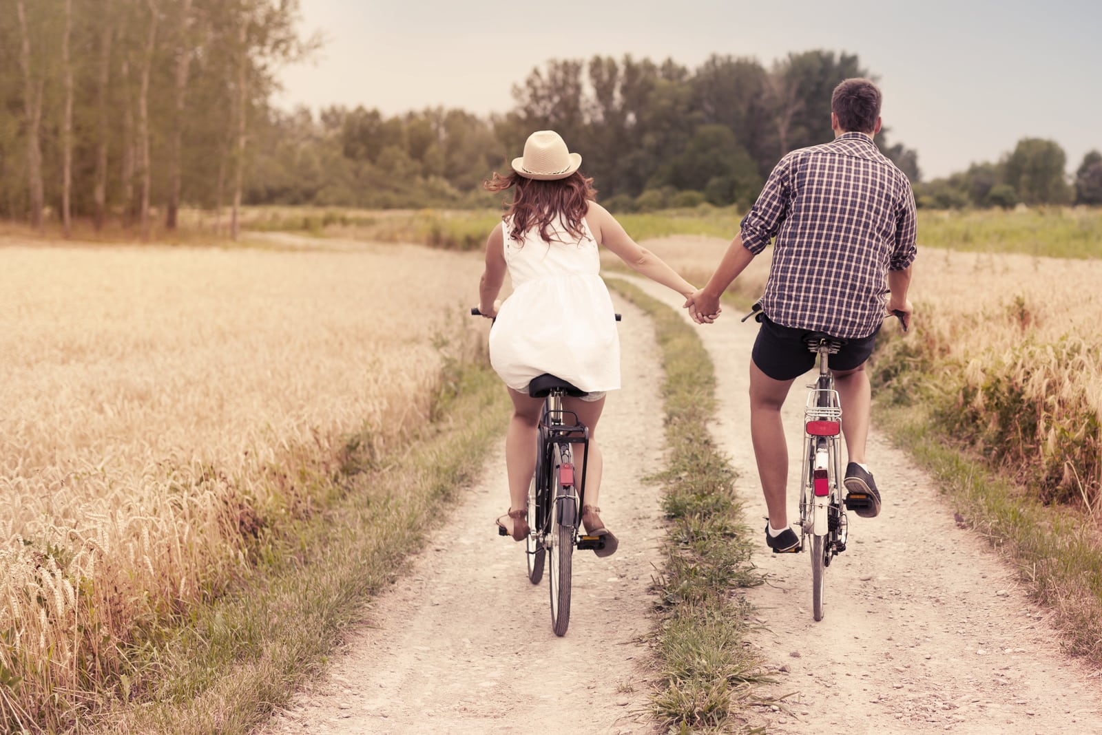 a loving couple rides bicycles