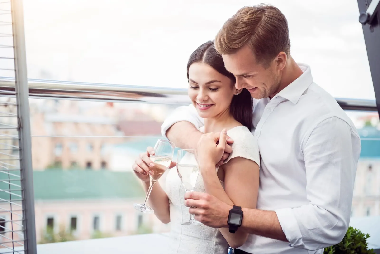 a man hugged a woman while drinking wine
