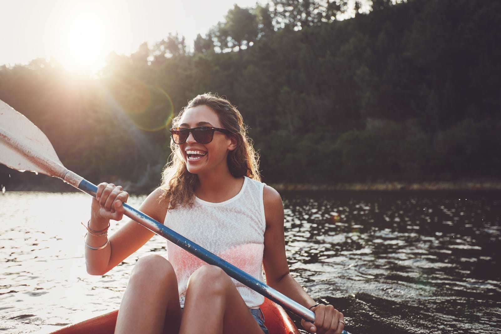 a smiling woman kayaking