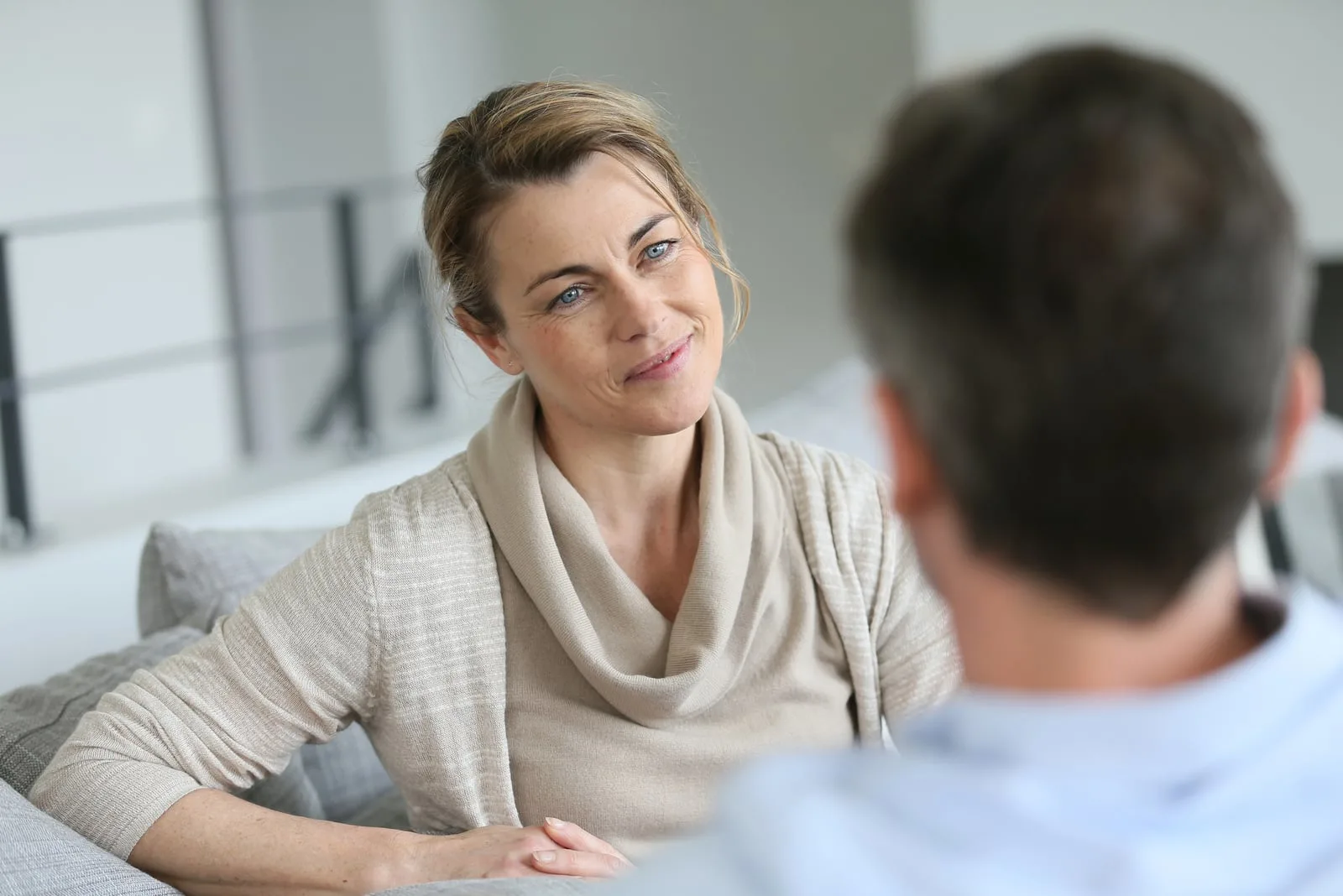 a woman talking to a man