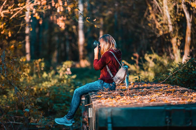 woman in nature taking pictures