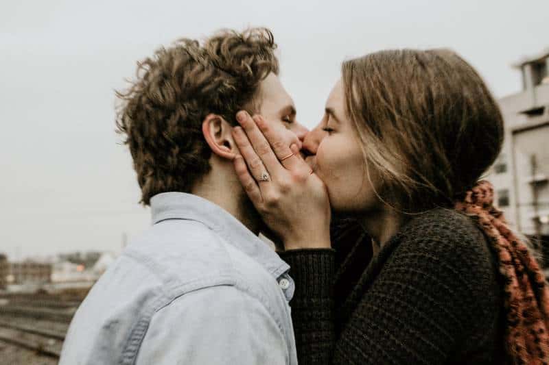 couple kissing each other outside