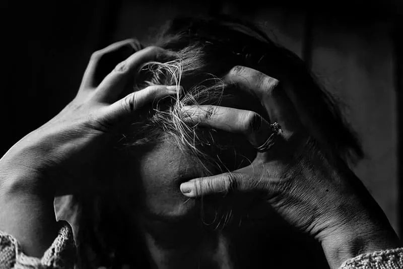 depressed woman grabing for her hair