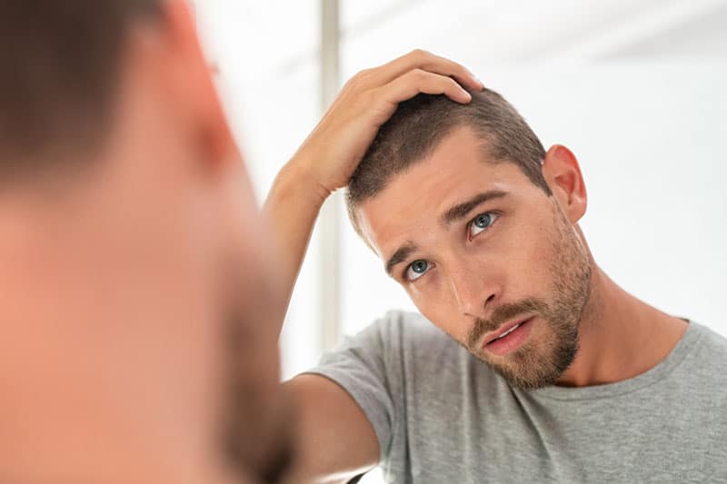 handsome man looking at mirror