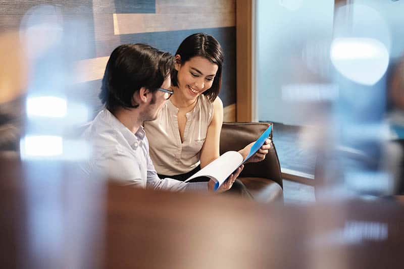 man and woman looking at papers