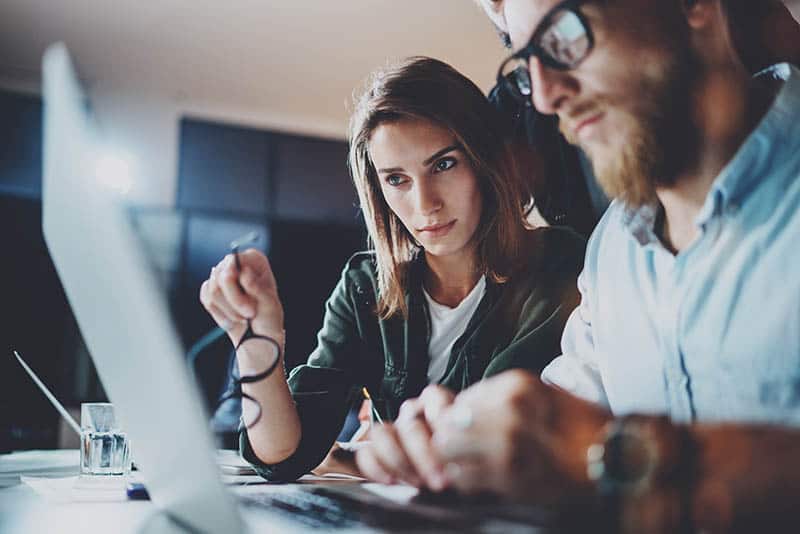 man and woman working at office