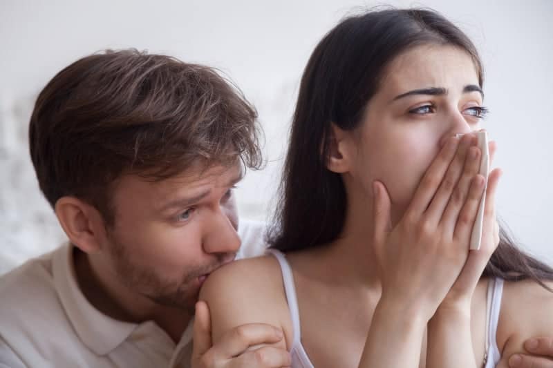 man comforting to crying woman