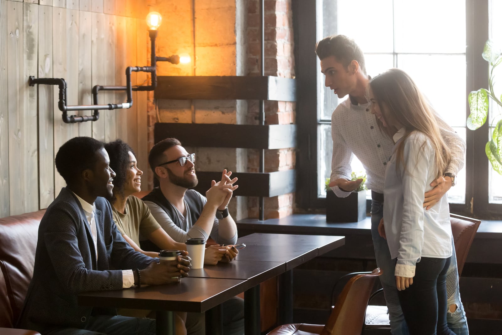 man introducing woman to his friends