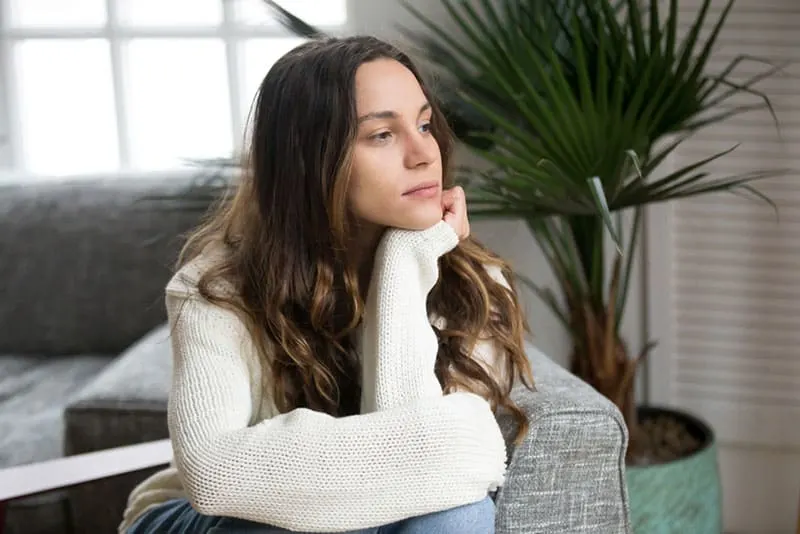 mindful young woman sitting in the living room