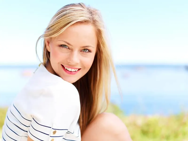 Young attractive woman near the ocean on a summer day