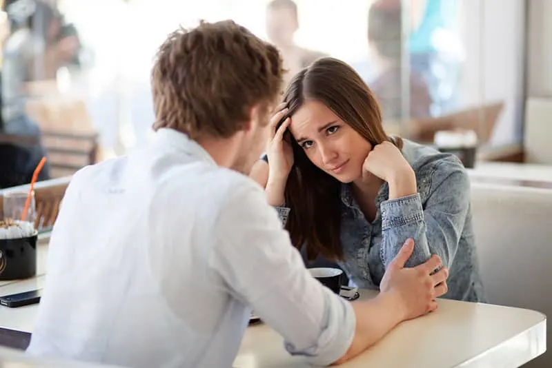 Young woman about to cry after having a fight with her boyfriend. In a cafe.