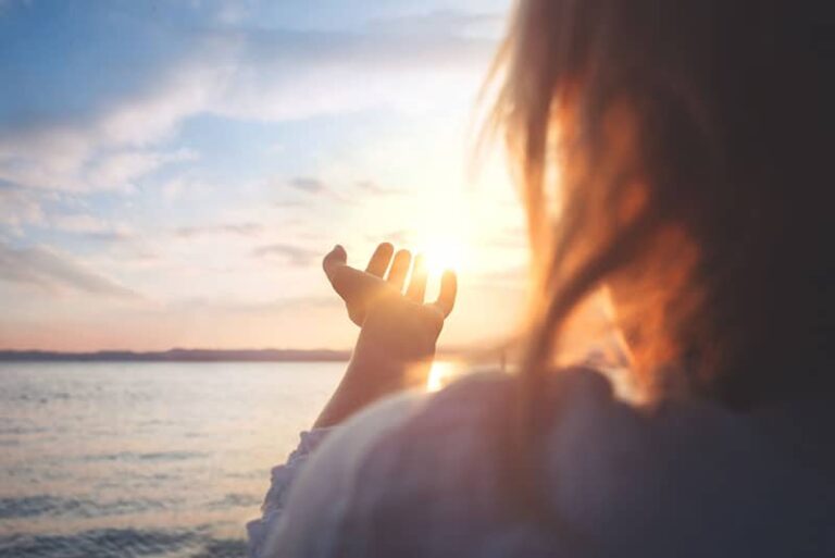 mujer tratando de agarrar el sol