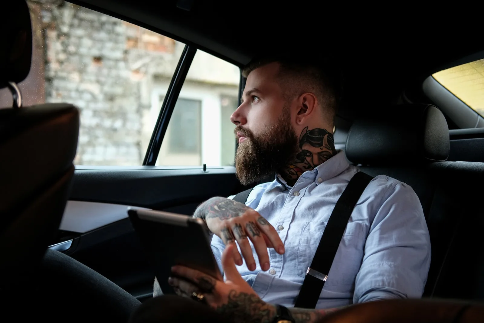 tattooed man sitting in the car