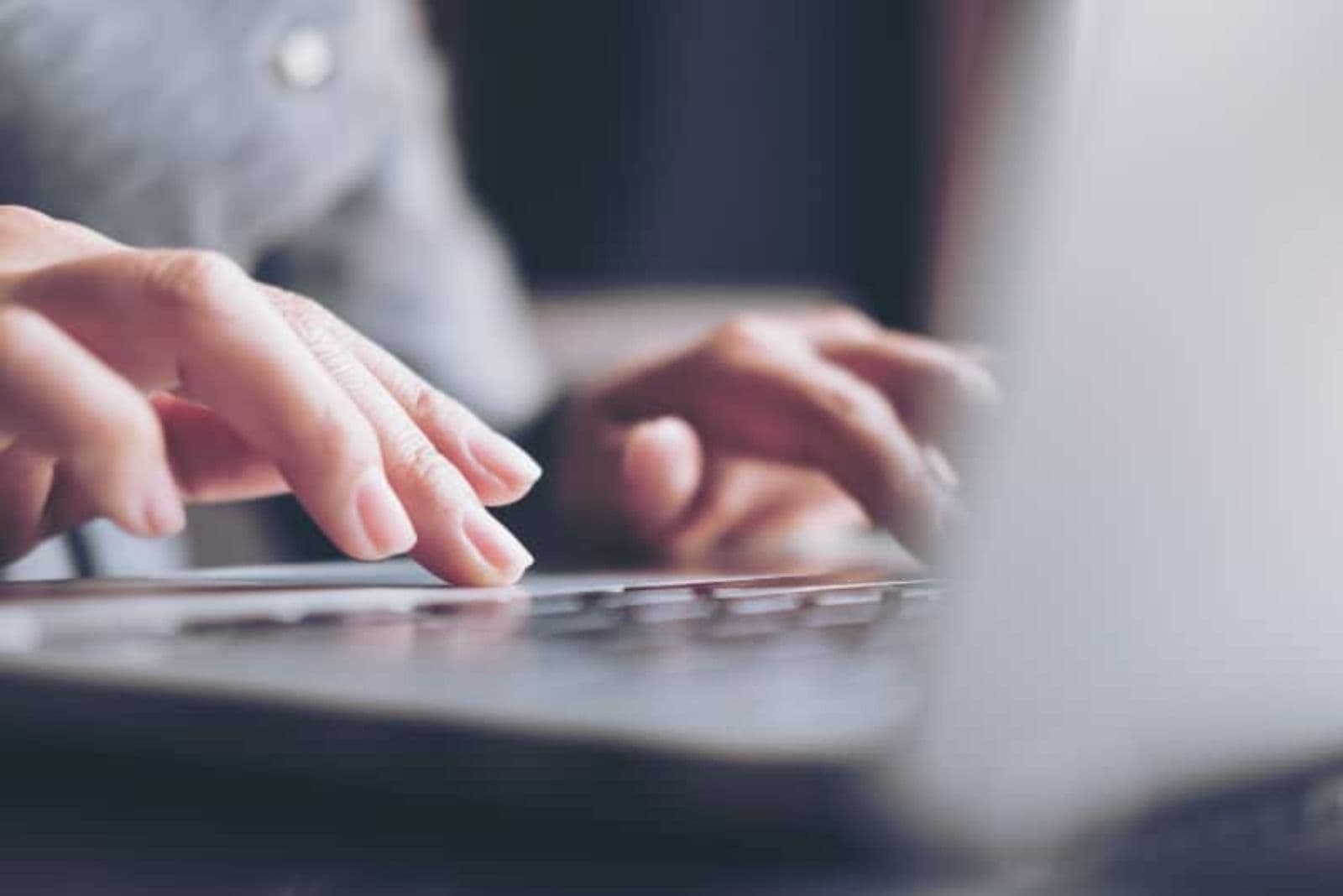 woman typing something on her laptop