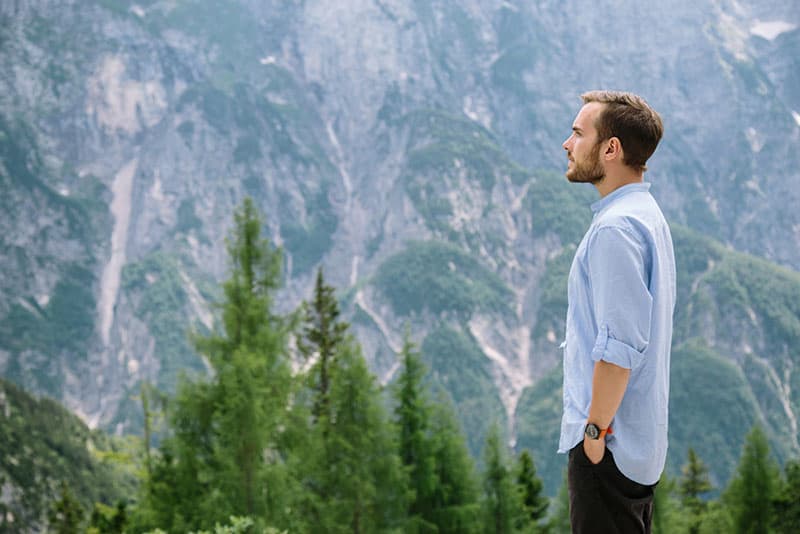 young man standing on the mountain